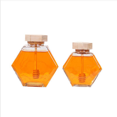 Verre résistant à la chaleur Honey Jar d'hexagone de dispositif d'écoulement en bois fournisseur