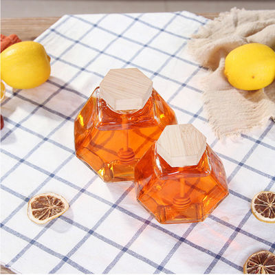 Verre résistant à la chaleur Honey Jar d'hexagone de dispositif d'écoulement en bois fournisseur